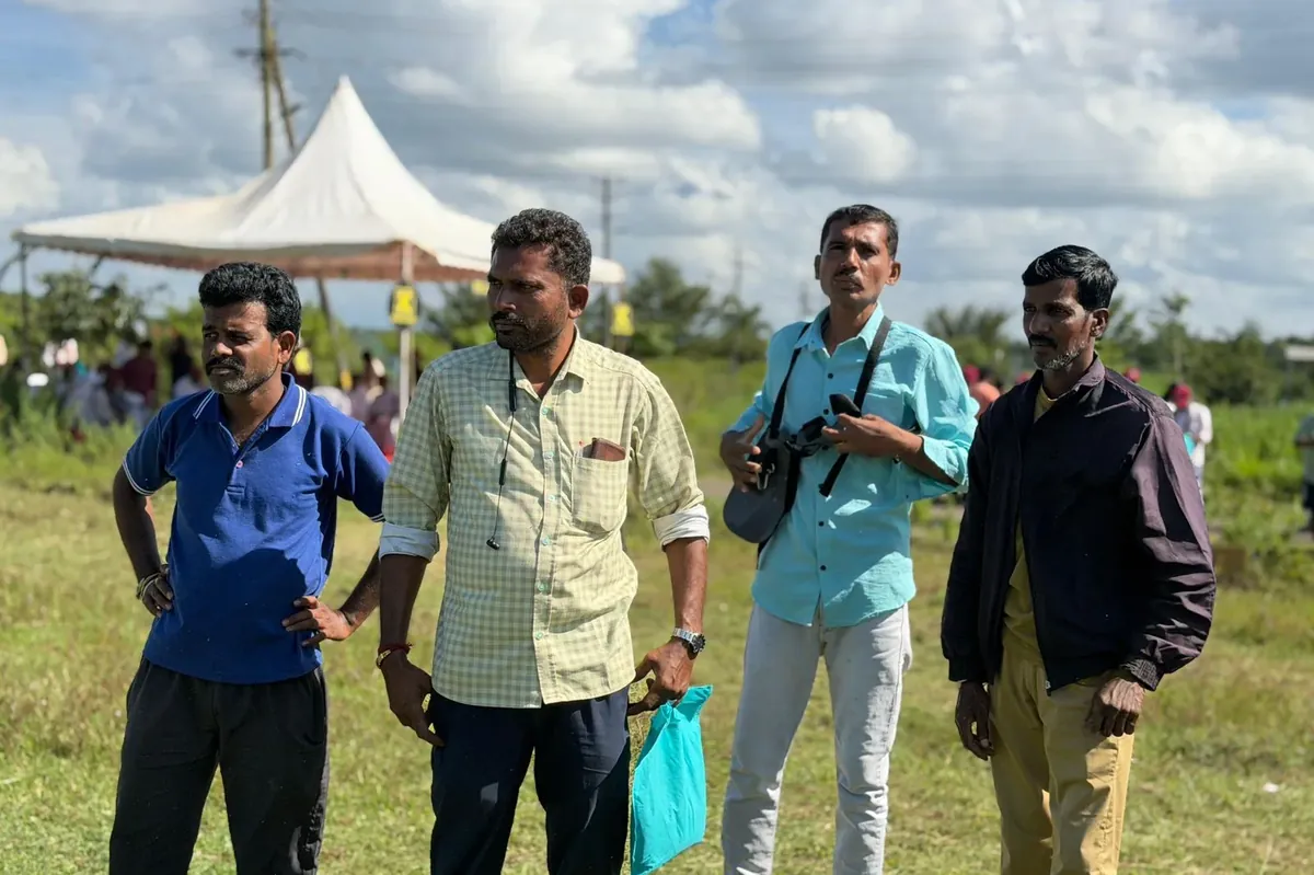 Four farmers standing in a field watching the RXB45 demonstration