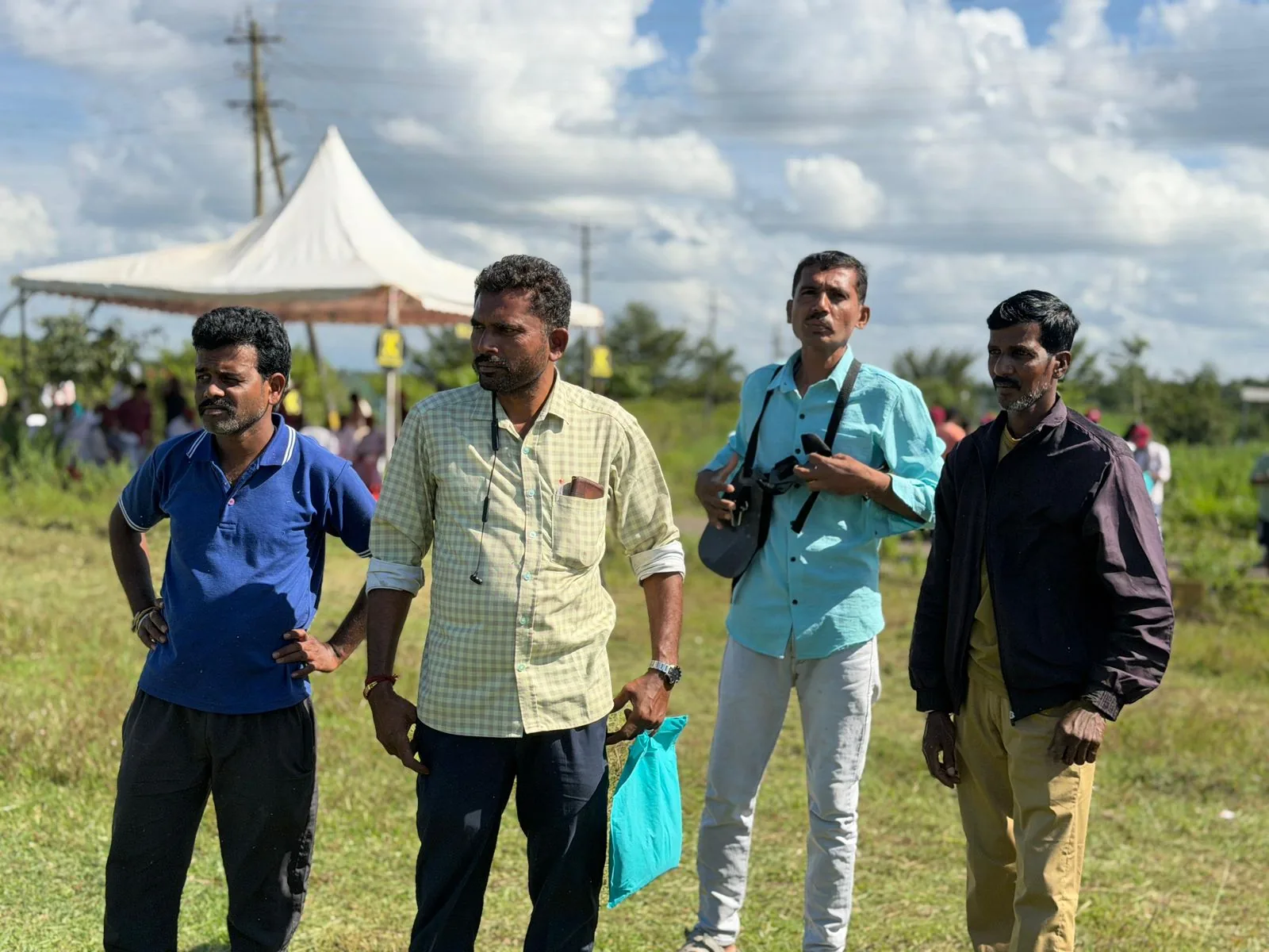 Four farmers watching the RXB45 field demonstration
